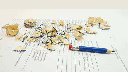 Small black pencil with shavings. Isolated on white background.の写真素材