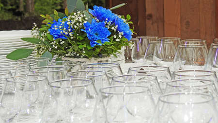 Beautiful blue wedding flowers. In glass vase on tableの写真素材