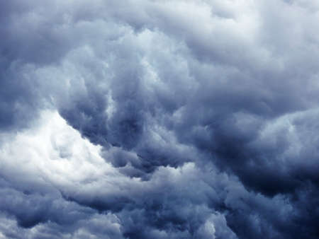 Massive dark blue clouds on sky before storm.