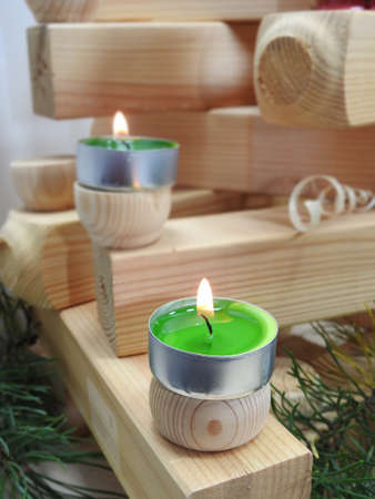 Small candles located on several wooden boards.の写真素材