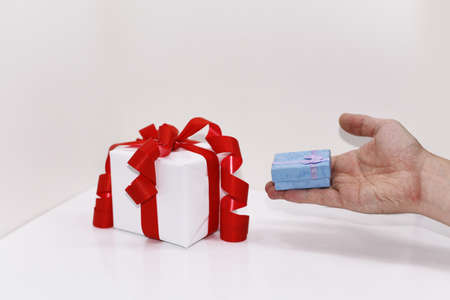 White presents with red ribbons, isolated on white background.の写真素材