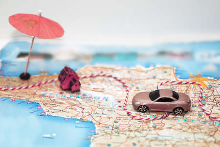 Abstract idea of rent a car. Small car on map.の写真素材