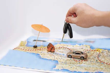 Abstract idea of rent a car. Small car on map.の写真素材