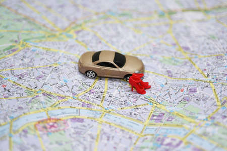 Woman drives car - abstract composition with small car and city map.