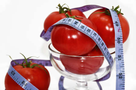Abstract composition of Diet. Tomatoes with blue centimeter in.の写真素材
