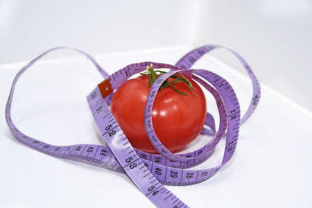 Abstract composition of Diet. Tomatoes with blue centimeter in.