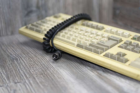 Retro isolated keyboard. Old technology abstraction on wooden background.の写真素材