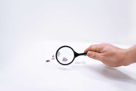 Mans hand with magnifying glass.の写真素材