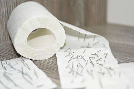 Toilet paper with nails in it.の写真素材