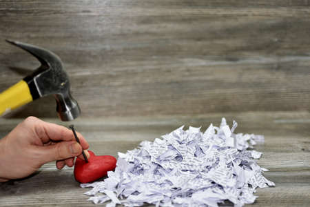 Abstraction of broken heart. Isolated on wooden background.の写真素材