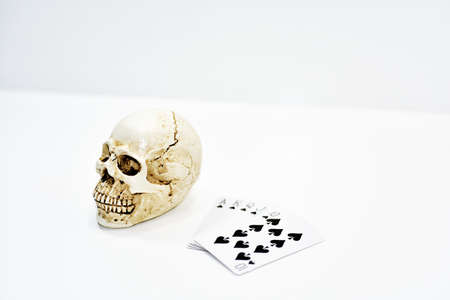 Small decorative human skull with playing cards.の写真素材