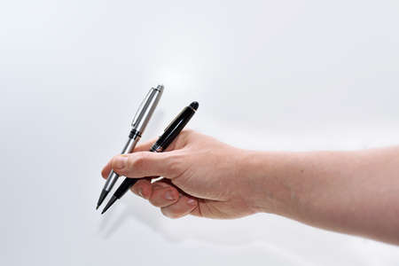 Two pans in mans hand.の写真素材