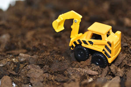 Small decorative excavator on ground. Macro abstract photo.の写真素材
