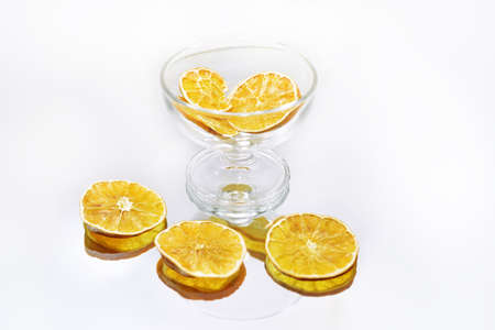 Glass dishes on mirror with reflection. Isolated on white background.の写真素材