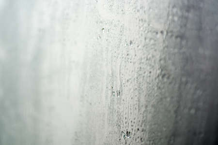 Drops of water on wet window. Macro photo.