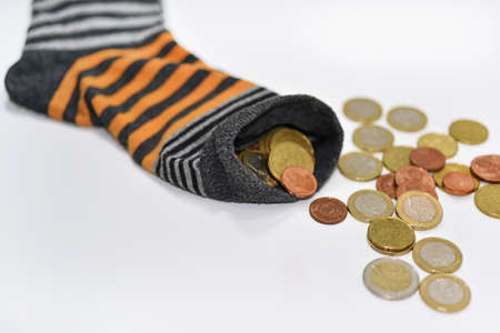 Money in sock. Abstract composition isolated on white background.の写真素材