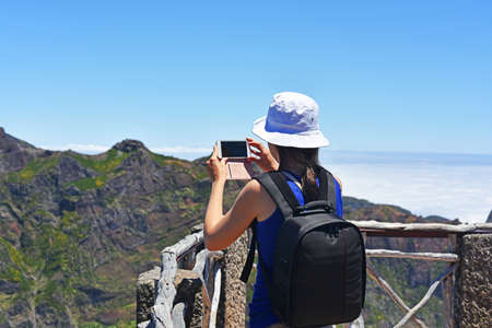 Young woman in Madeira's mountains above the cloudsの写真素材