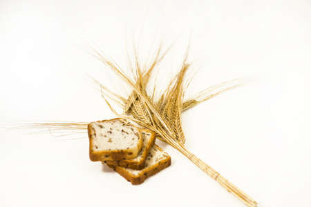 Freshly baked traditional bread with ears of wheat. Isolated on white background