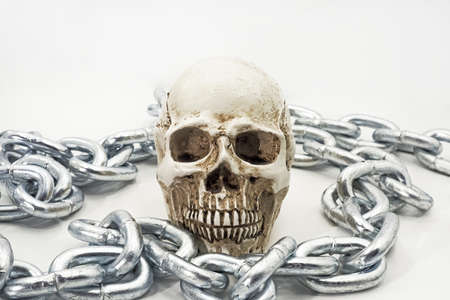 Human skull with iron chain.の写真素材
