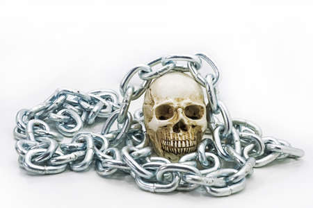 Human skull with iron chain. Isolated on white background.の写真素材