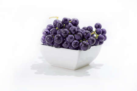 Raw dark grapes isolated on white background.の写真素材