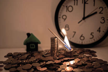 Burning match on euro coins. Abstract dark photo.の写真素材