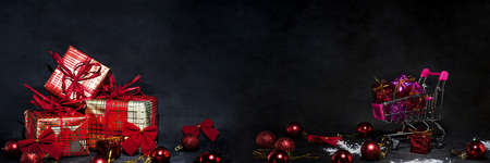 Black Friday abstract photo. Happy Merry Christmas. Shopping cart with decorative presents.の写真素材