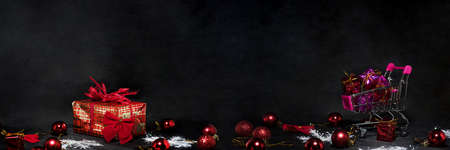 Black Friday abstract photo. Happy Merry Christmas. Shopping cart with decorative presents.の写真素材