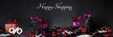 Black Friday abstract photo. Happy Merry Christmas. Shopping cart with decorative presents.の写真素材
