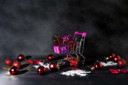 Black Friday abstract photo. Happy Merry Christmas. Shopping cart with decorative presents.の写真素材