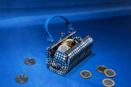 Euro coins in small case isolated on blue background.の写真素材