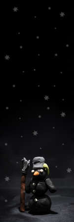 Black Friday abstract photo. Happy Merry Christmas. Snowman made from plasticine on black background.の写真素材