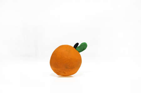 Plasticine artwork. Handmade orange. Abstract isolated photoの写真素材