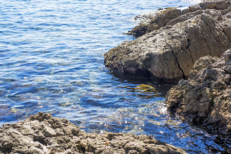 Group of stones near Atlantic ocean coast. On Summer cloudy day.の写真素材