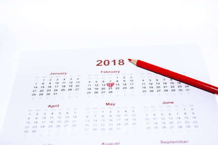 Valentine day abstract photo. Calendar with pencil isolated on white background.