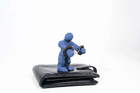 Theft and fraud. Small figure made from Play Clay with purse isolated on white background.の写真素材