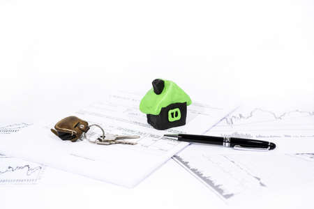 Abstract photo of buying, selling property. House made from Play Clay with documents and pen.の写真素材