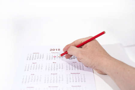 Valentine day abstract photo. Calendar with pencil isolated on white background.の写真素材