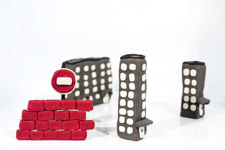Abstract photo of buildings works. Figures made from Play Clay. Isolated on white background.