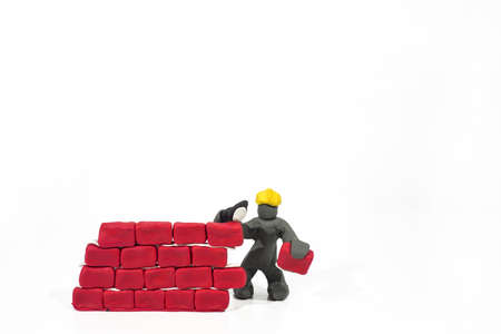 Abstract photo of buildings works. Figures made from Play Clay. Isolated on white background.