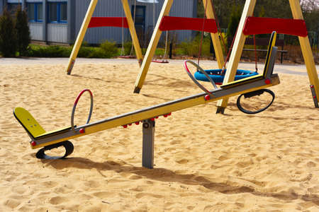 Empty child playground on sand. Spring abstract photo.の写真素材