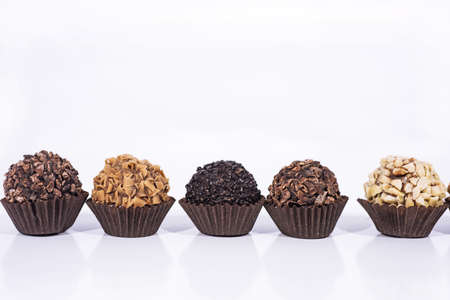 Sweet chocolate candies balls with nuts. Abstract photo of chocolate industry.