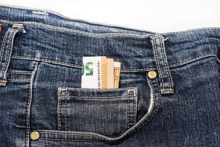 Euro banknotes in jeans. Abstract photo of money spending and money security, safety.
