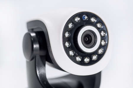 Spy video camera isolated on white background. Abstract surveillance idea through web camera.