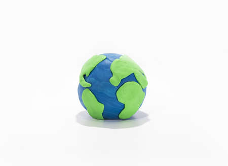 Small Earth model with human hands. Abstract composition of peace.の写真素材
