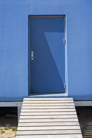 Abstract photo. Blue isolated door from outside.