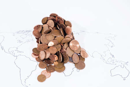 A lot of coins on World Map. Abstract photo of world economy.の写真素材