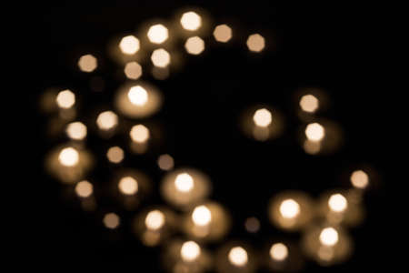 Symbols of Islam. Candle lights on black background. Abstract isolated photo.