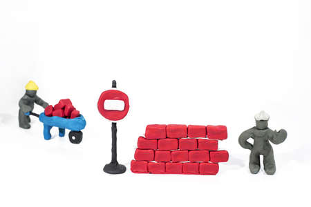 Abstract photo of buildings works. Figures made from Play Clay. Isolated on white background.