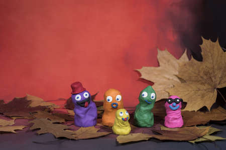 Small funny figures made from Play Clay. Autumn abstraction.